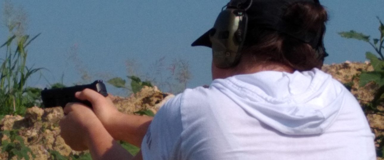 woman preparing to fire a handgun