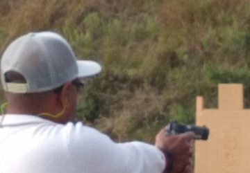 Man aiming handgun at target during armed self defense class at Urban Defense Academy in Liberty Hill Texas