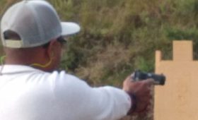 Man aiming handgun at target during armed self defense class at Urban Defense Academy in Liberty Hill Texas