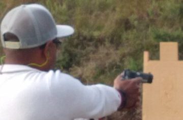 Man aiming handgun at target during armed self defense class at Urban Defense Academy in Liberty Hill Texas
