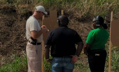 Instructor talking to a married couple about their targets. They are taking a handgun training class at Urban Defense Academy.