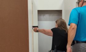 Woman learning to search, clear and secure and area, such as her home, during the Practical Pistol Course Series at Urban Defense Academy in Liberty Hill Texas