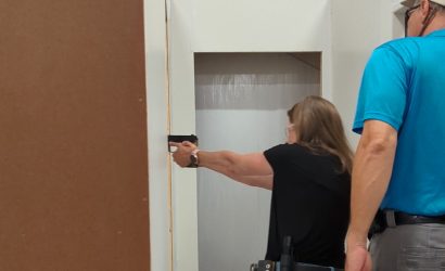 Woman learning to search, clear and secure and area, such as her home, during the Practical Pistol Course Series at Urban Defense Academy in Liberty Hill Texas