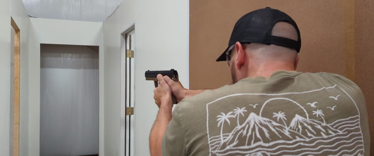 A man taking a handgun training course at Urban Defense Academy in Liberty Hill Texas. He is learning to search and clear an area, such as a home for home defense purposes.