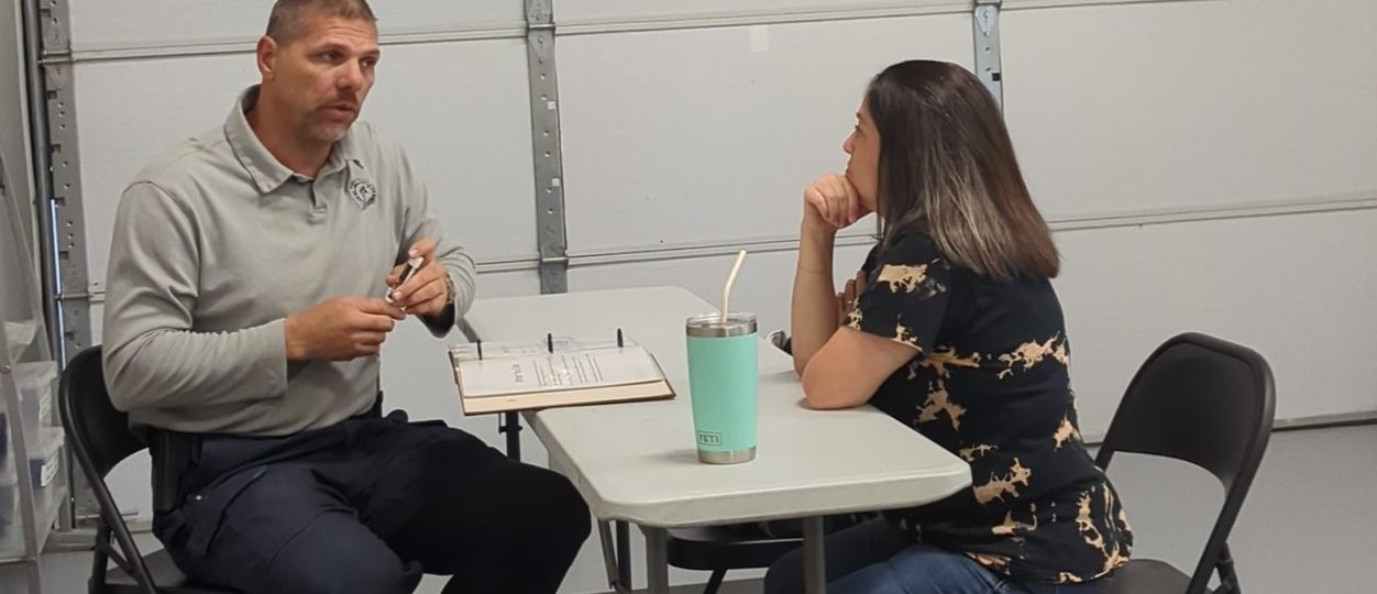 Instructor talking to woman at Free Consultation for handgun training
