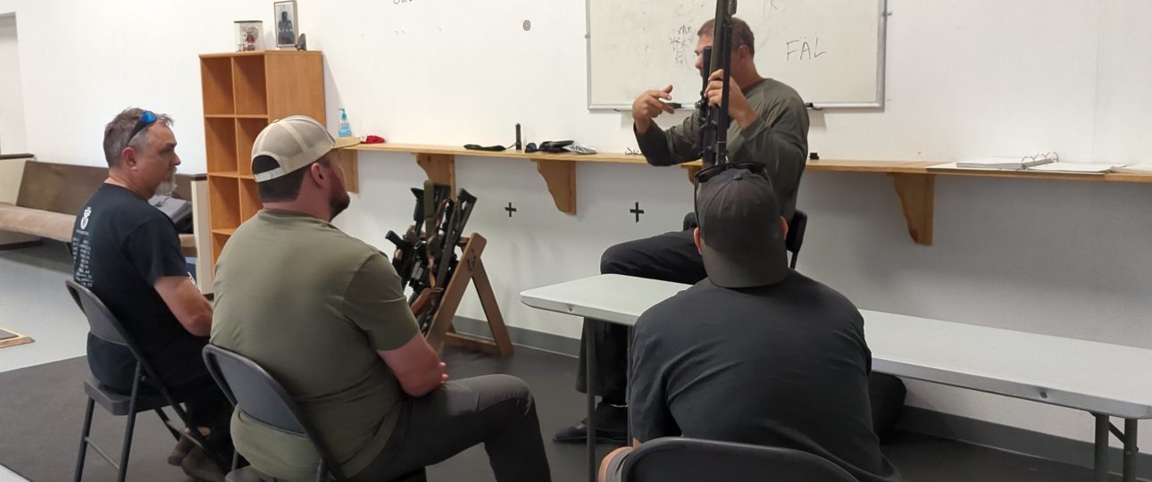 UDA20251122_125848 - Armed Self Defense Firearms Training Instructor talking to 3 men during a Free Consultation for rifle training at Urban Defense Academy in Liberty Hill Texas